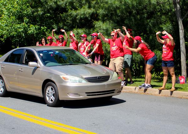 红帽学生欢迎汽车进入校园